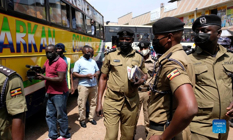 Police officers are seen at a bus terminal in Kampala, Uganda, on Oct. 26, 2021. Police on Tuesday morning spent several hours at the bus terminals in the capital Kampala, urging people to be vigilant and report any suspicious characters. Bus operators were also instructed to resume security checks of all passengers boarding.(Photo: Xinhua)