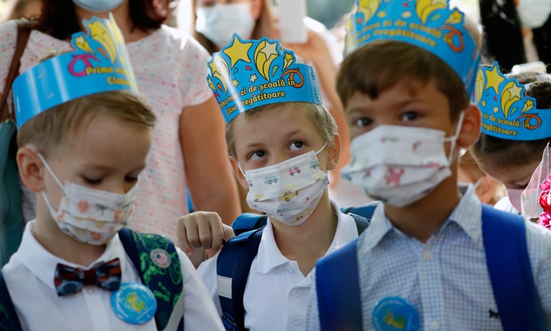 Children wait for the official opening of a new school year at a school in Bucharest, Romania, on Sept. 13, 2021.(Photo: Xinhua)