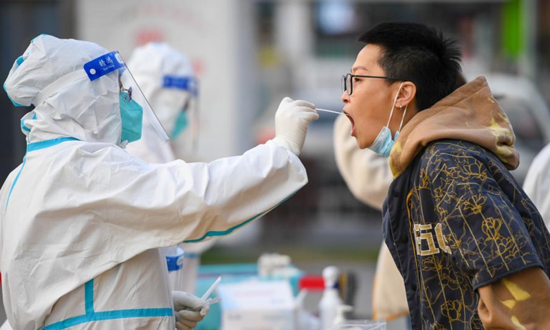 A medical worker takes a swab sample from a resident for nucleic acid testing in Hohhot, north China's Inner Mongolia Autonomous Region, on Oct. 29, 2021.Photo:Xinhua