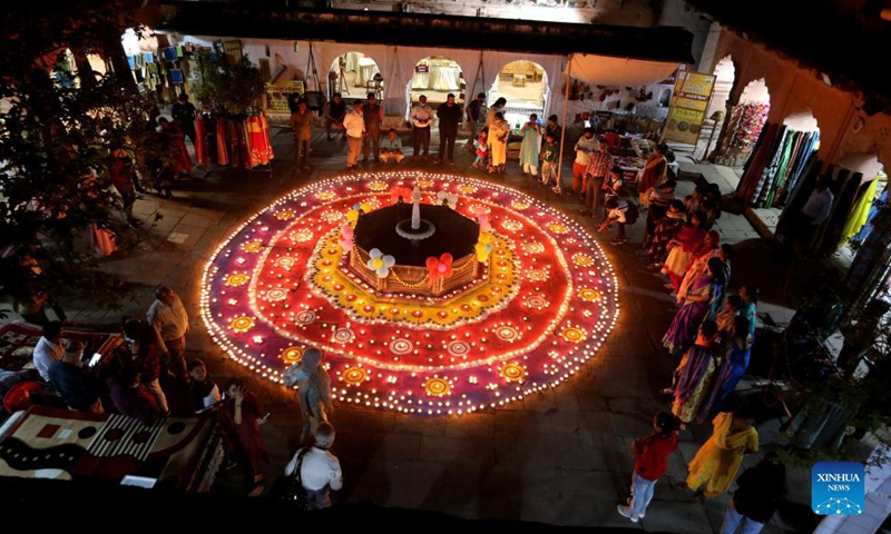 People gather around oil lamps lit for the upcoming Diwali festival in Bhopal, the capital city of India's Madhya Pradesh, on Oct. 29, 2021.Photo:Xinhua