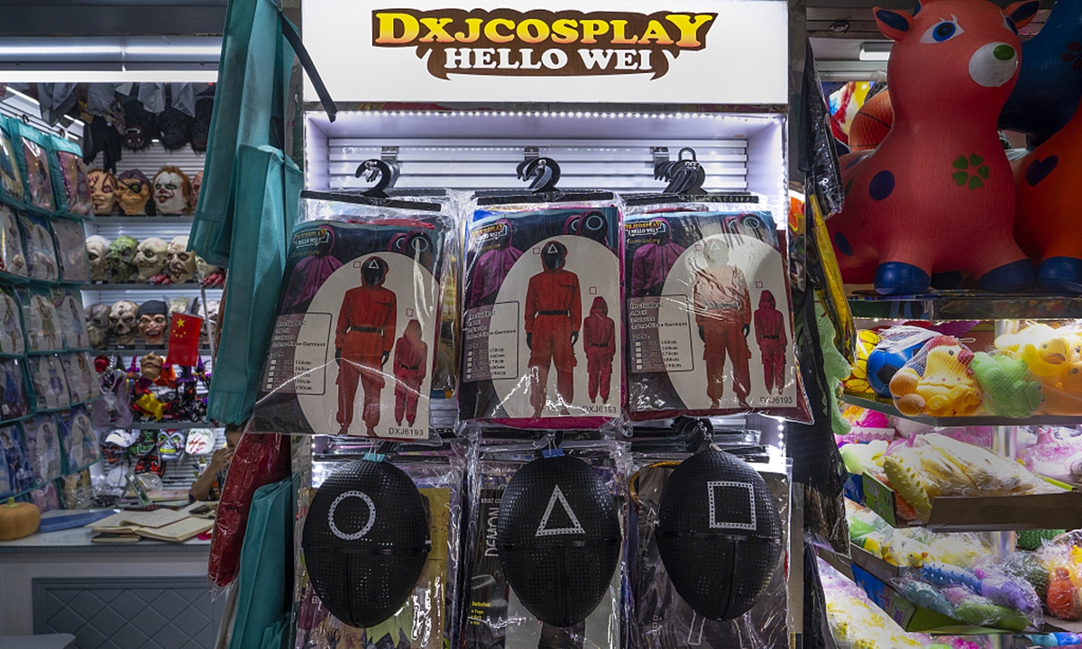 Costumes and masks inspired by <em>Squid Game</em> are on display in a shop at Yiwu Wholesale Market on October 13, 2021 in Yiwu, Zhejiang Province, China.Photo: VCG