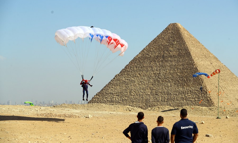 A skydiver flies over pyramids during the Jump Like a Pharaoh skydiving festival held in the Pyramids of Giza, Egypt, on Nov. 1, 2021.(Photo: Xinhua)