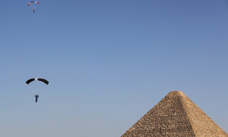 A skydiver flies over the pyramids during the Jump Like a Pharaoh skydiving festival held in the Pyramids of Giza, Egypt, on Nov. 1, 2021.(Photo: Xinhua)