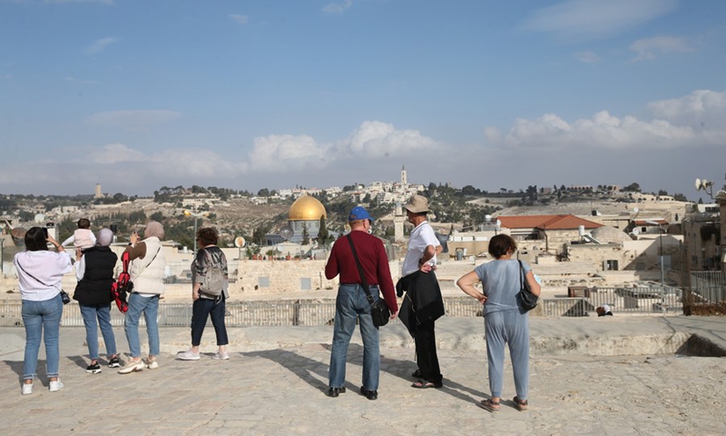 Photo taken on Nov. 2, 2021 shows tourists taking pictures of the Old City of Jerusalem.(Photo: Xinhua)