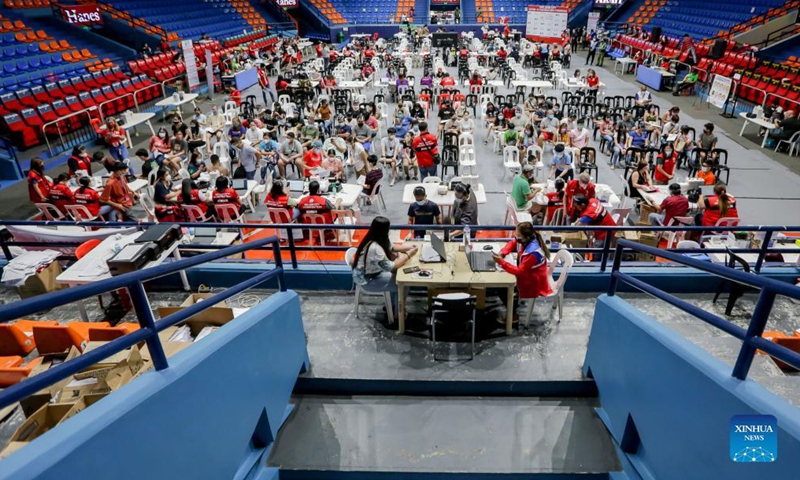 Parents and their children are seen as they wait for their turn to be inoculated with COVID-19 vaccine at a vaccination site in San Juan City, the Philippines on Nov. 3, 2021. The Philippine government has initiated its national COVID-19 immunization program to children aged 12 to 17 on Wednesday.(Photo: Xinhua)