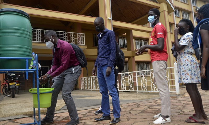 Students line up to wash their hands at Makerere University in Kampala, Uganda, Nov. 1, 2021. (Photo: Xinhua)