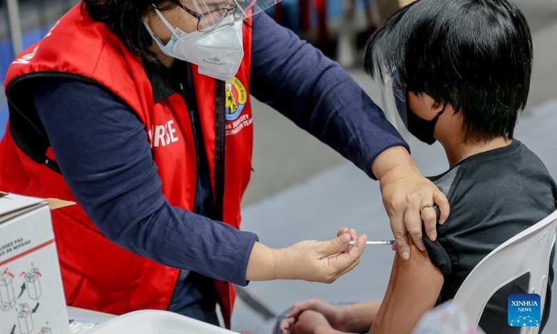 A boy is inoculated with a COVID-19 vaccine at a vaccination site in San Juan City, the Philippines on Nov. 3, 2021. The Philippine government has initiated its national COVID-19 immunization program to children aged 12 to 17 on Wednesday. (Photo: Xinhua)