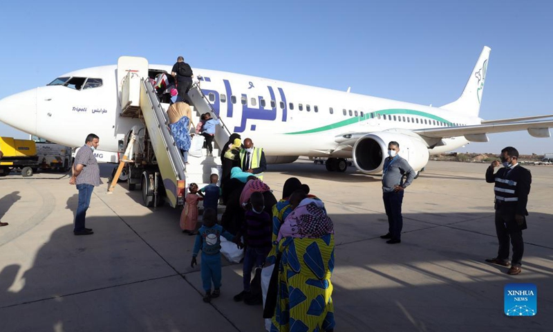 Illegal immigrants queue to board a plane at Misurata International Airport in Misurata, Libya, on Nov. 3, 2021. A group of 91 illegal immigrants, mostly children, on Wednesday were voluntarily repatriated from Libya to their home country Niger.(Photo: Xinhua)