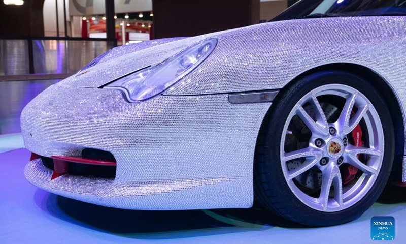 Photo taken on Nov. 5, 2021 shows a Porsche sports car decorated with gems at the Consumer Goods Exhibition Area of the 4th China International Import Expo (CIIE) in east China's Shanghai. The Porsche car is decorated with nearly 400,000 gems, which were made by craftsmen by hand for several months.Photo:Xinhua
