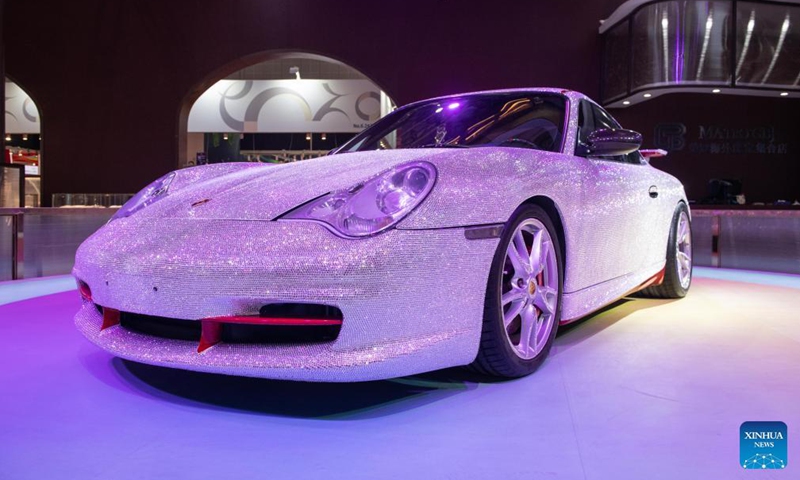 Photo taken on Nov. 5, 2021 shows a Porsche sports car decorated with gems at the Consumer Goods Exhibition Area of the 4th China International Import Expo (CIIE) in east China's Shanghai. The Porsche car is decorated with nearly 400,000 gems, which were made by craftsmen by hand for several months.Photo:Xinhua