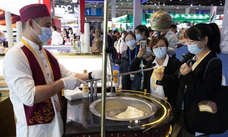 A staff member makes ice-cream at the Food and Agricultural Products Exhibition Area of the 4th China International Import Expo (CIIE) in east China's Shanghai, Nov. 6, 2021. Various foods from around the world are showcased during the 4th CIIE in Shanghai.Photo:Xinhua