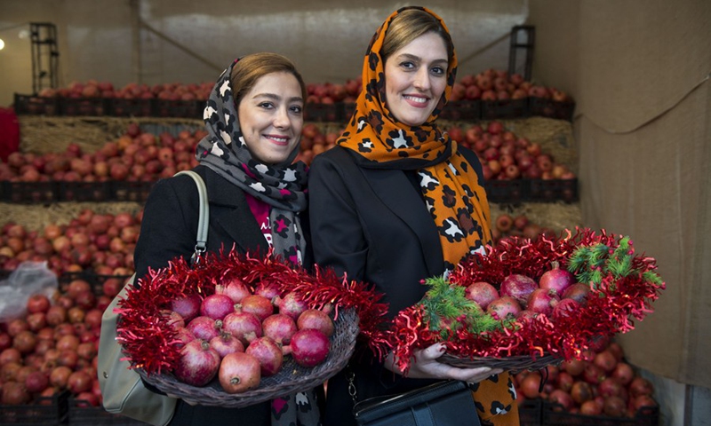 Iranian women hold pomegranates during a pomegranate festival held at the Water and Fire Park in Tehran, Iran, on Nov. 9, 2021.(Photo: Xinhua)
