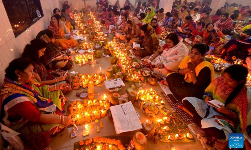 Hindu devotees sit for prayer with burning incense and oil lamps during the Rakher Upobash, a religious fasting festival, at a temple in Dhaka, Bangladesh, on Nov. 13, 2021.Photo:Xinhua