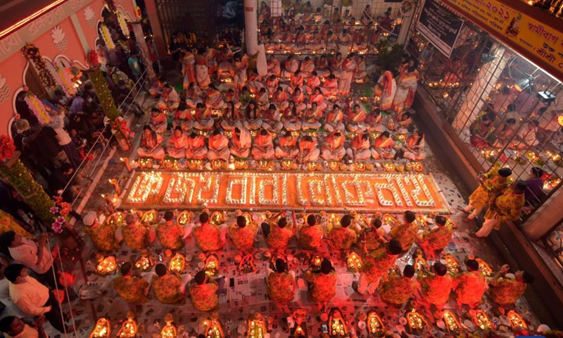 Hindu devotees sit for prayer with burning incense and oil lamps during the Rakher Upobash, a religious fasting festival, at a temple in Dhaka, Bangladesh, on Nov. 13, 2021.Photo:Xinhua