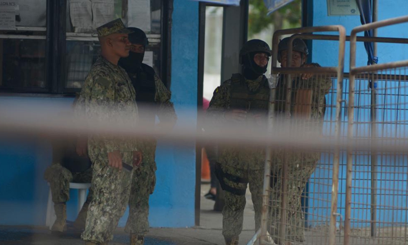 Police officers stand guard outside the Litoral Penitentiary after clashes occurred in the prison in Guayaquil, Ecuador, Nov. 13, 2021.Photo:Xinhua