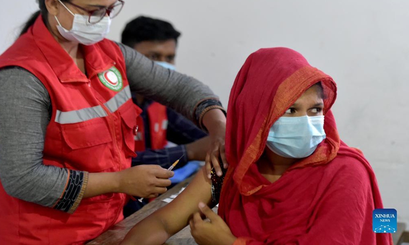 A woman receives a dose of COVID-19 vaccine at a slum in Dhaka, Bangladesh, Nov. 16, 2021. (Xinhua) 