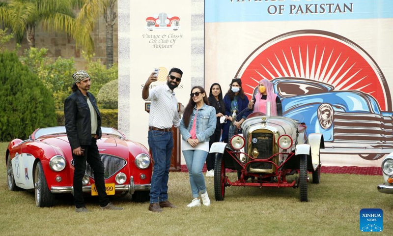 People visit a vintage and classic car show in Islamabad, Pakistan, Nov. 16, 2021. The show was organized by Vintage and Classic Car Club of Pakistan (VCCCP) in Islamabad on Tuesday, displaying more than 25 vintage and classic vehicles. (Xinhua/Ahmad Kamal) 
