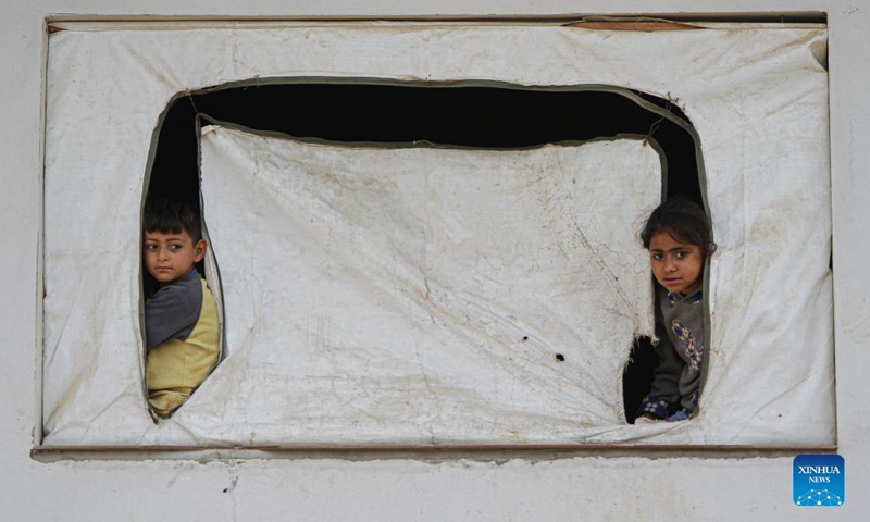 Children look out from their house in Jabalia refugee camp in northern Gaza Strip, Nov. 16, 2021. (Photo by Rizek Abdeljawad/Xinhua) 