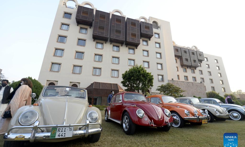 People visit a vintage and classic car show in Islamabad, Pakistan, Nov. 16, 2021. The show was organized by Vintage and Classic Car Club of Pakistan (VCCCP) in Islamabad on Tuesday, displaying more than 25 vintage and classic vehicles. (Xinhua/Ahmad Kamal)  