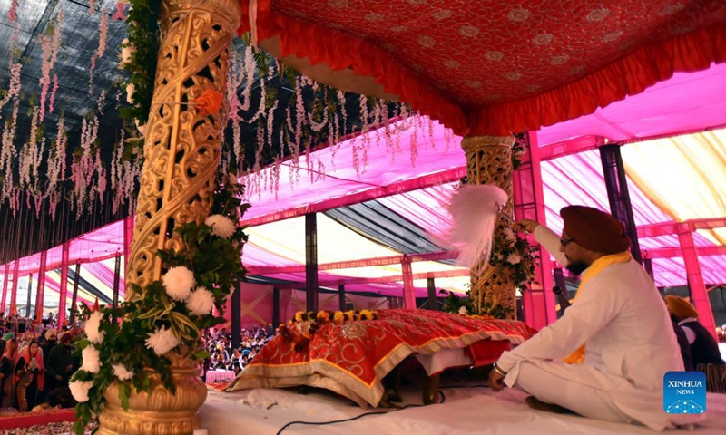 Sikh devotees offer prayers during celebrations to mark the birth anniversary of the first Sikh Guru, Guru Nanak Dev, at a Gurudwara, or Sikh temple, in Jammu, the winter capital of Indian-controlled Kashmir, Nov. 19, 2021. (Photo by Nitin Kanotra/Xinhua)
