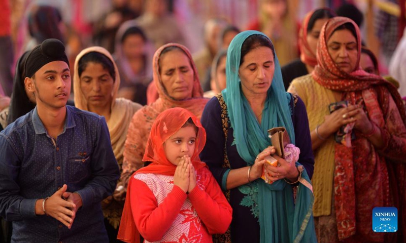 Sikh devotees offer prayers during celebrations to mark the birth anniversary of the first Sikh Guru, Guru Nanak Dev, at a Gurudwara, or Sikh temple, in Jammu, the winter capital of Indian-controlled Kashmir, Nov. 19, 2021. (Photo by Nitin Kanotra/Xinhua)
