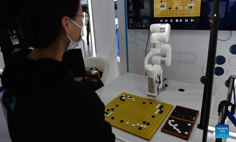 A visitor plays a Go game with a robot at the fourth World Manufacturing Convention in Hefei, east China's Anhui Province, Nov. 19, 2021. The fourth World Manufacturing Convention kicked off Friday in Hefei, capital of east China's Anhui Province. The four-day event, themed innovation-driven, digitally empowered: global manufacturing industry aligned for high-quality growth, aims to promote high-quality manufacturing and deepen exchanges between China and the rest of the world. (Xinhua/Huang Bohan)