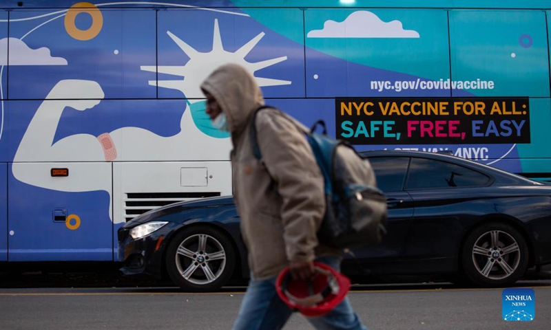 A pedestrian walks in front of a COVID-19 vaccination site in the Brooklyn borough of New York, the United States, Nov 19, 2021. The US Food and Drug Administration (FDA) on Friday authorized boosters of the Pfizer/BioNTech and Moderna COVID-19 vaccines for all adults.Photo:Xinhua