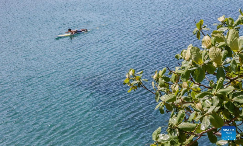 A tourist is seen on a paddleboard in Batangas Province, the Philippines on Nov 18, 2021.Photo:Xinhua