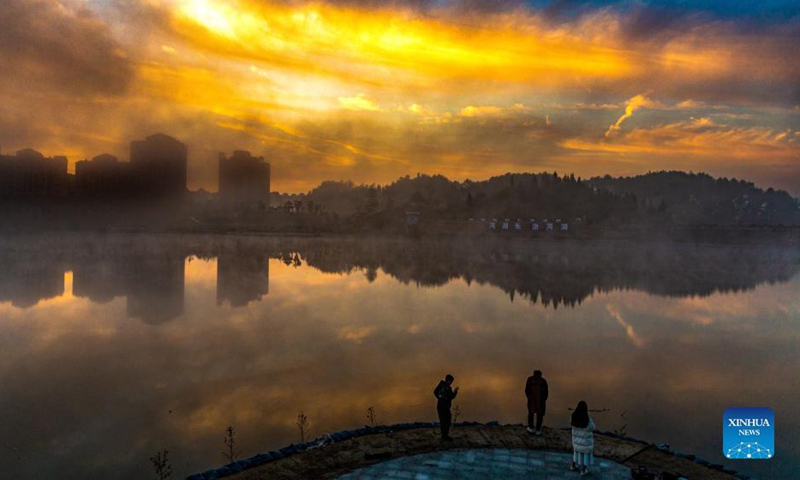 Photo taken on Nov. 25, 2021 shows the sunrise scenery of Lixiang Lake National Wetland Park in Nanchuan District, southwest China's Chongqing Municipality. Local authorities of Nanchuan District have in recent years made all-out efforts to strengthen ecological protection of Lixiang Lake. The endeavor has yielded blue skies and clear waters as well as booming tourism. (Photo by Qu Mingbin/Xinhua)