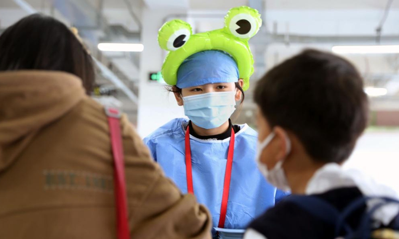 A medical worker wearing cartoon head decoration works at a vaccination site in Xuhui District of Shanghai, east China, Nov. 20, 2021.Photo:Xinhua