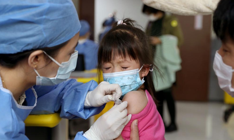 A four-year-old girl receives COVID-19 vaccine at a vaccination site in Xuhui District of Shanghai, east China, Nov. 20, 2021.Photo:Xinhua
