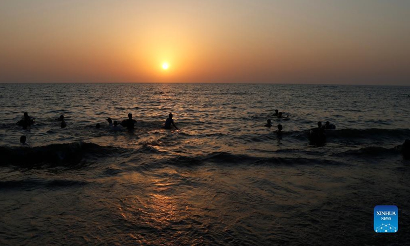 People enjoy themselves on the beach in Hodeidah, Yemen, Nov. 19, 2021. (Photo by Mohammed Mohammed/Xinhua) 