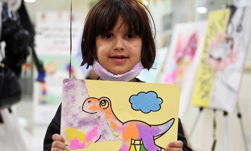 A girl looks at exhibits during an exhibition of artistic paintings for children in Hawalli Governorate, Kuwait, on Nov. 22, 2021.Photo:Xinhua