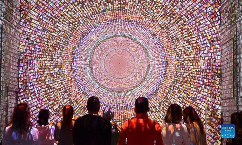People visit a digital art exhibition at a movie theater in Istanbul, Turkey, on Nov. 24, 2021. A digital art exhibition, created by using artificial intelligence (AI), fascinates art lovers at a newly renovated ancient movie theater in Istanbul.(Photo:Xinhua)