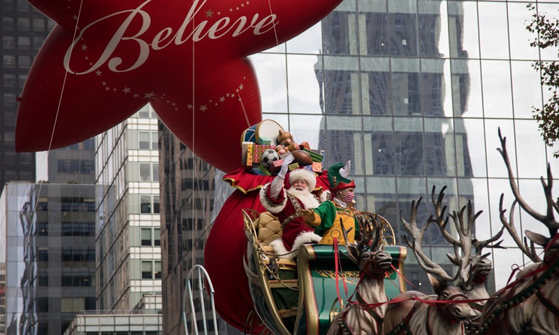 A performer dressed in Santa Claus costume rides on a float during the Macy's Thanksgiving Day Parade in New York, the United States, Nov. 25, 2021.(Photo: Xinhua)