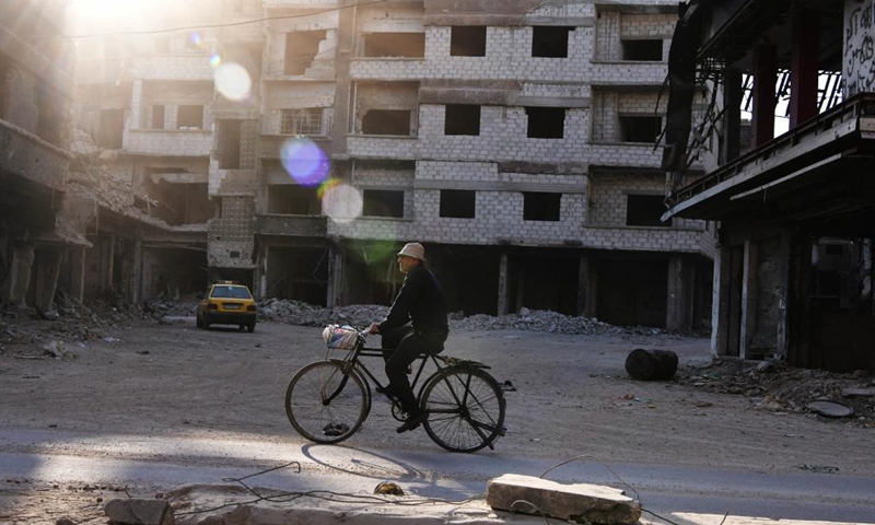 A man rides a bike at the Yarmouk Camp in the south of Damascus, Syria, on Nov. 17, 2021.Photo:Xinhua