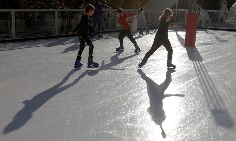 Children enjoy ice skating in Bucharest, Romania, Nov. 27, 2021.Photo:Xinhua