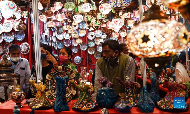 A vendor waits for customers at his booth during an international trade fair in New Delhi, India, Nov. 27, 2021.Photo:Xinhua