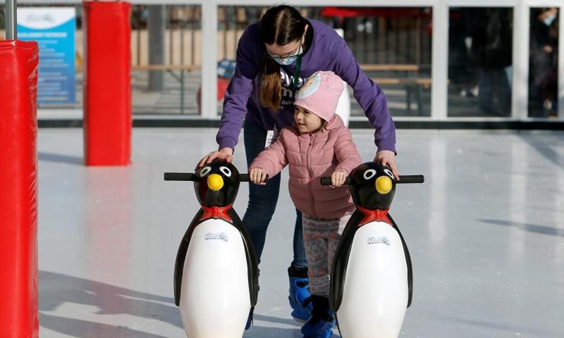 A child learns ice skating in Bucharest, Romania, Nov. 27, 2021.Photo:Xinhua