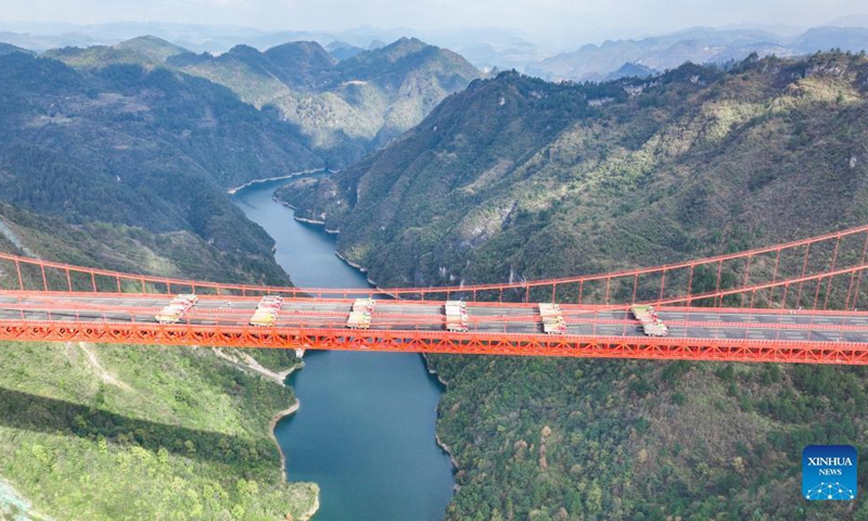 Aerial photo taken on Nov. 30, 2021 shows the Yangbaoshan bridge during a static load test in Guiding County, southwest China's Guizhou Province. The Yangbaoshan bridge carried out a static load test on Tuesday. Forty-eight large trucks with a total of 1,680 tonnes of goods were parked on the bridge to test the construction quality and mechanical properties of the bridge structure.(Photo: Xinhua)