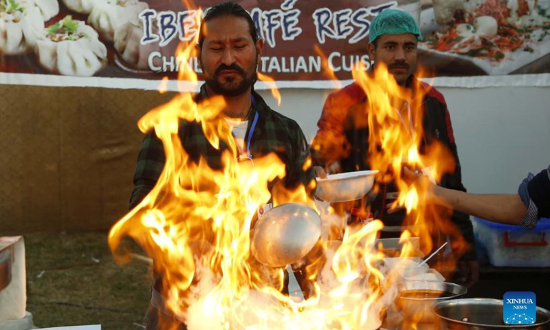 A man prepares food during a food festival in Islamabad, Pakistan, on Dec 3, 2021. The three-day food festival Islamabad Taste kicked off on Friday in Islamabad with more than 100 food stalls offering a variety of food to visitors.Photo:Xinhua