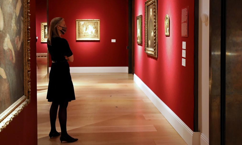 A woman views artworks for auction during a media preview of the Christie's London Classic Week auction in London, Britain, Dec. 3, 2021. Christie's London Classic Week presents art from antiquity to the 21st century, spanning five live auctions and four online-only sales.Photo:Xinhua