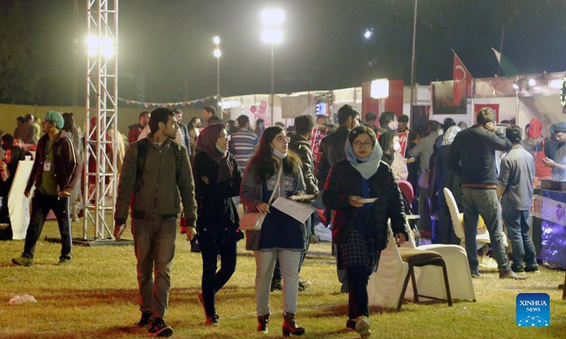People visit a food festival in Islamabad, Pakistan, on Dec 3, 2021. The three-day food festival Islamabad Taste kicked off on Friday in Islamabad with more than 100 food stalls offering a variety of food to visitors.Photo:Xinhua