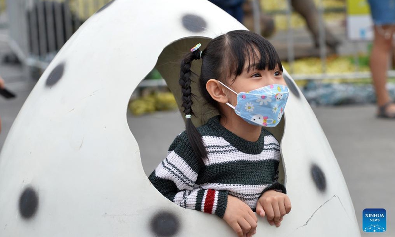 A child is seen at the Dino Fest in Bangkok, Thailand, on Dec 2, 2021. The Dino Fest kicked off on Dec. 2 and will last until Dec. 12, showcasing more than 50 dinosaur models.Photo:Xinhua