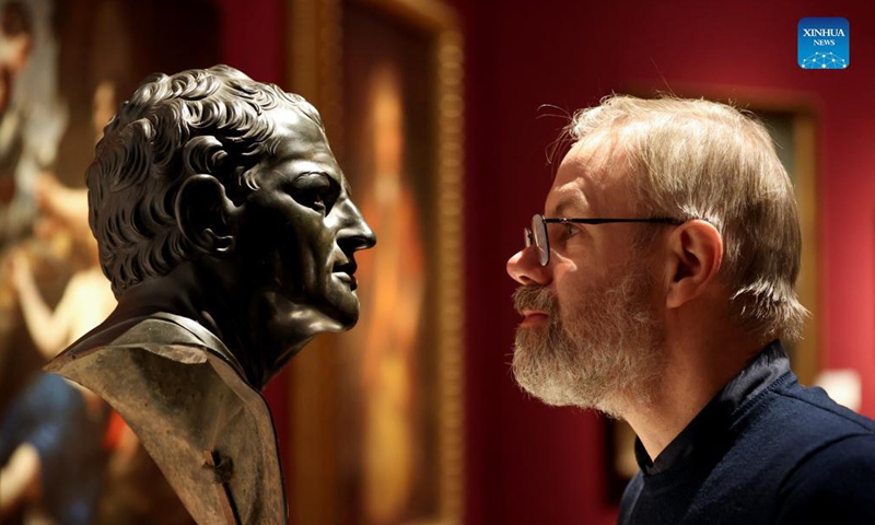 A man views an artwork for auction during a media preview of the Christie's London Classic Week auction in London, Britain, Dec. 3, 2021. Christie's London Classic Week presents art from antiquity to the 21st century, spanning five live auctions and four online-only sales.Photo:Xinhua