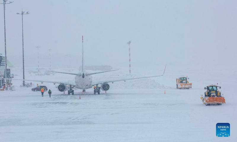 Snow plows are seen at the Riga International Airport in Riga, Latvia, on Dec. 4, 2021.Photo:Xinhua