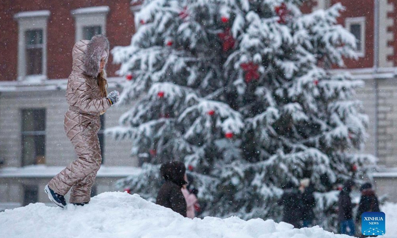 A child plays in the snow in Riga, Latvia, on Dec. 4, 2021.Photo:Xinhua