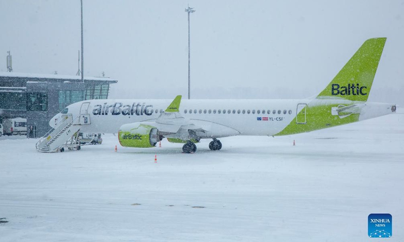 An airplane is seen during a heavy snowfall at the Riga International Airport in Riga, Latvia, on Dec. 4, 2021.Photo:Xinhua