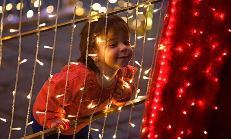 A child is seen in front of Christmas decorations in downtown Beirut, Lebanon, on Dec. 6, 2021.(Photo: Xinhua)