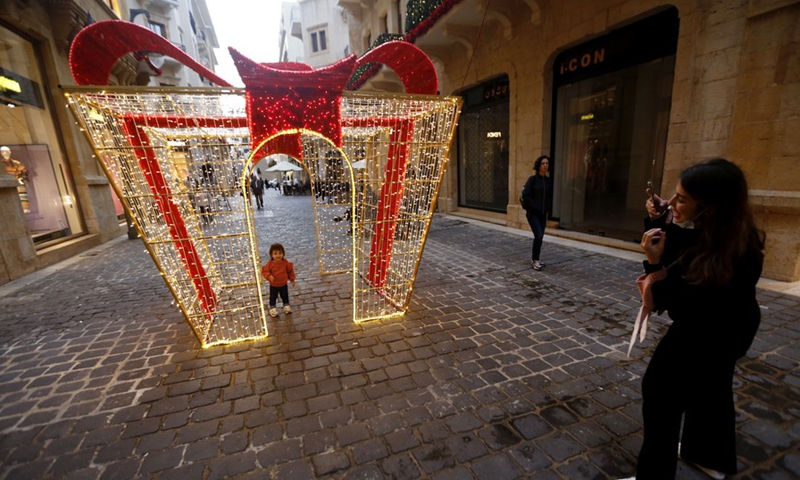 Child poses for photos inside a Christmas installation in downtown Beirut, Lebanon, on Dec. 6, 2021.(Photo: Xinhua)